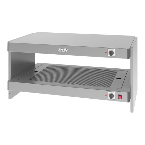 A Cadco countertop warmer on a counter with a stainless steel shelf and two drawers.