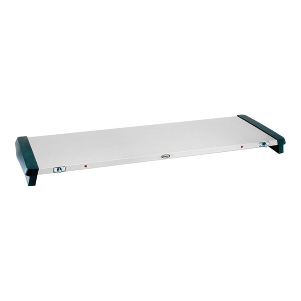 A white rectangular electric warming shelf with black handles and a logo on top.