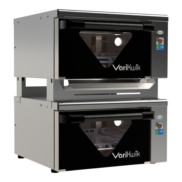 A stack of black and silver Cadco VariKwik ovens with a Cadco VK-SK Stacking Kit on a counter.