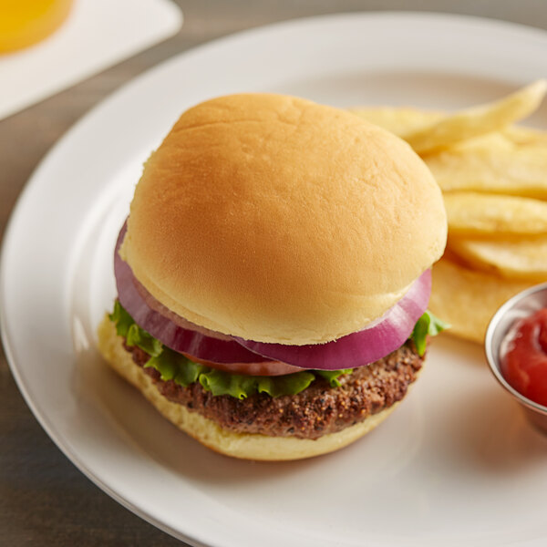 A burger on a Martin's Sandwich Potato Roll with fries on a plate.