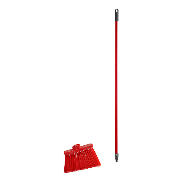 A red broom head with angled bristles.