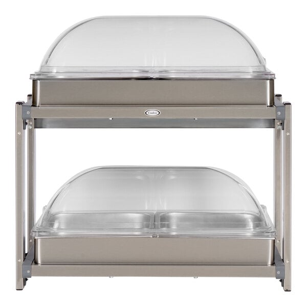 A Cadco countertop food warmer with two roll top lids over glass trays.