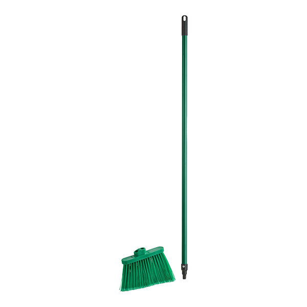 A green broom head with angled bristles.