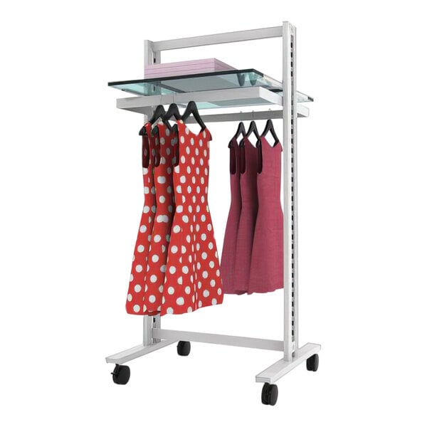 A white Udizine mobile retail clothing display rack with two dresses on it.