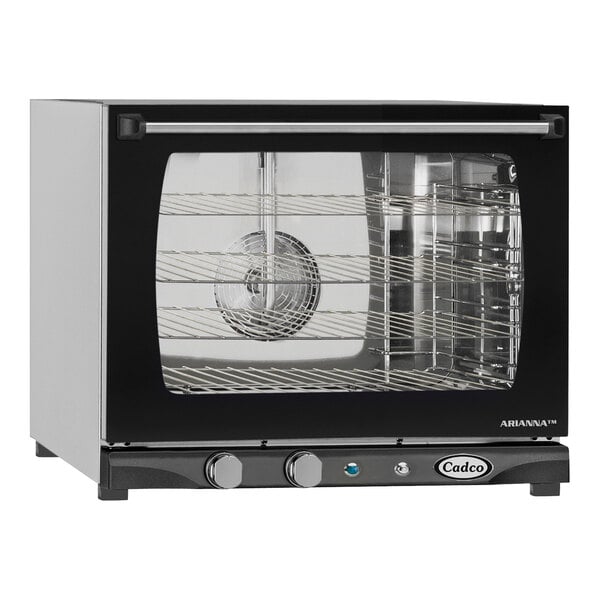 A black and silver Cadco countertop convection oven with a glass door.