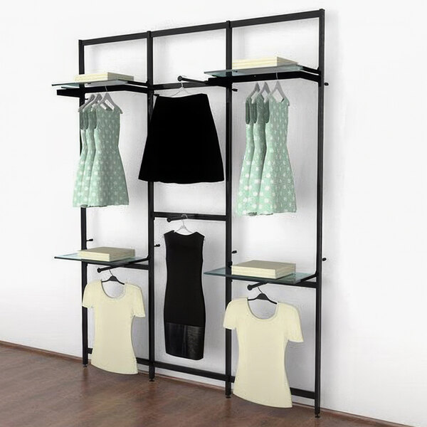 A black Udizine wall-mounted retail clothing display with clothes on it.