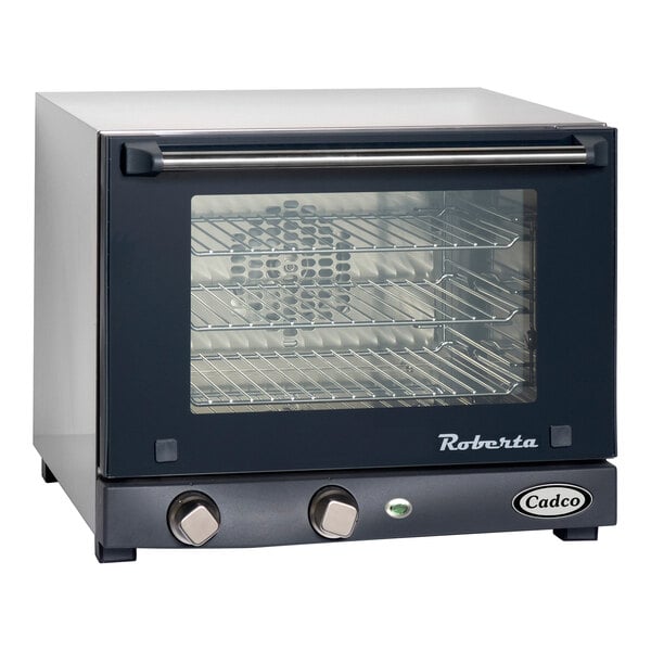 A black and silver Cadco countertop convection oven with a glass door.