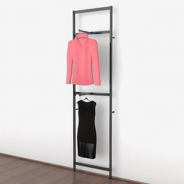 A black Udizine clothing display with a black and pink shirt, jacket, and dress on it.