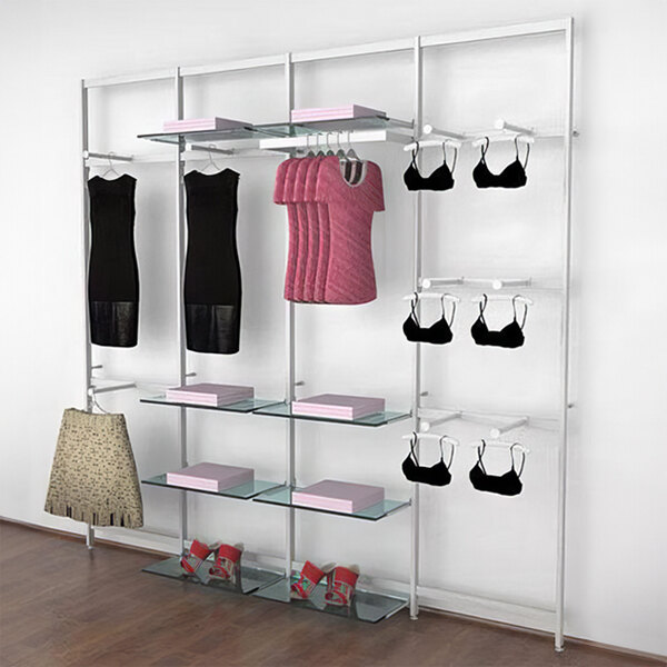 A white Udizine Vertik retail clothing display rack with shelves, faceouts, and a hanging rail holding clothes and accessories.