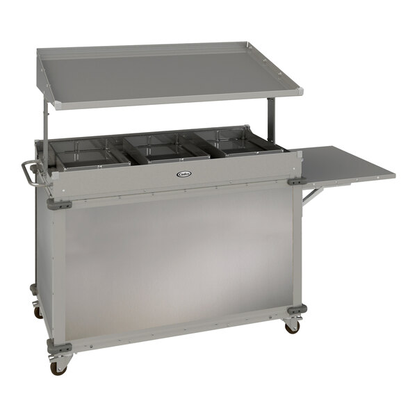 A silver Cadco MobileServ stainless steel food cart on a school kitchen counter.