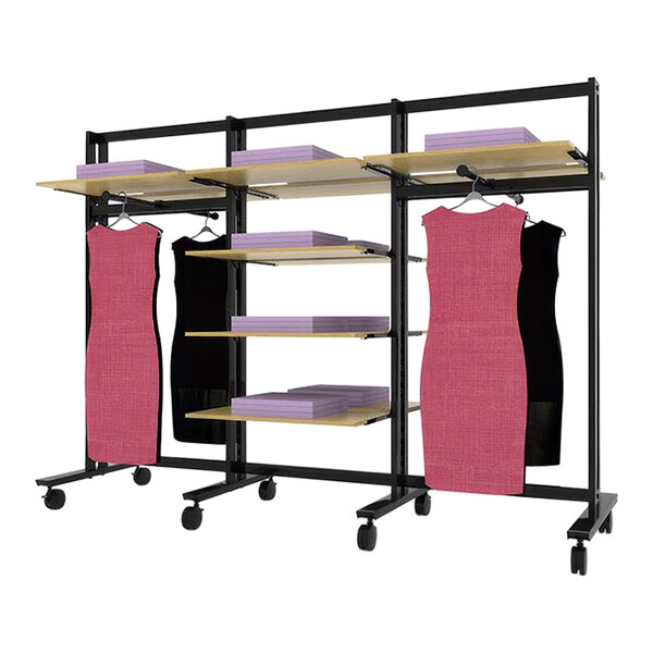 A black Udizine mobile retail clothing display stand with pink dresses on it.