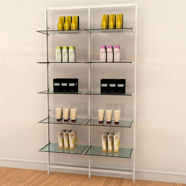 A white Udizine wall-mounted retail clothing display with shelves holding different products.