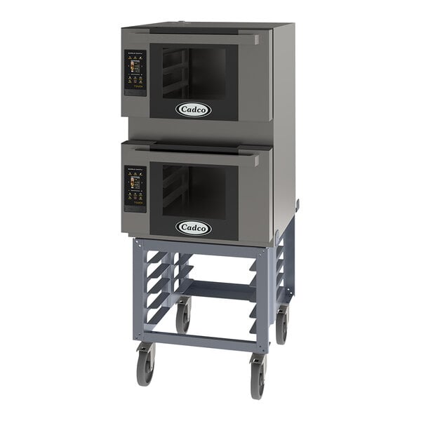 A grey Cadco Bakerlux double stacked countertop convection oven on a cart.