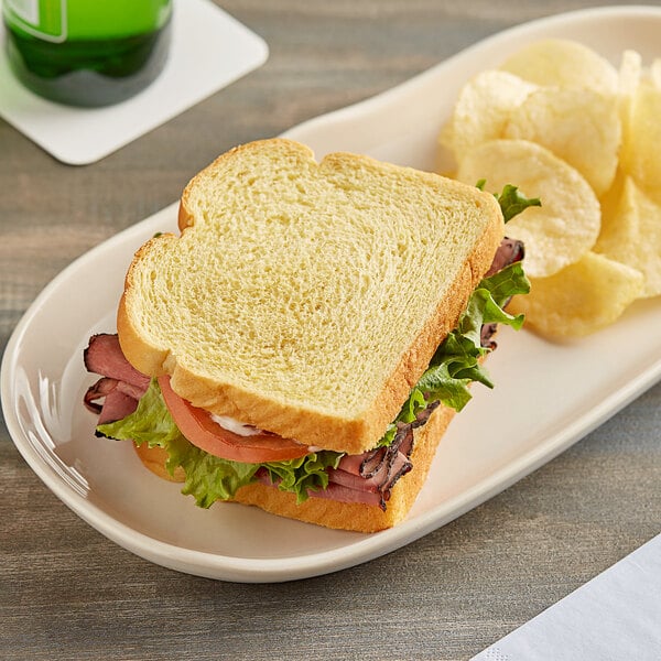 A sandwich on a plate with Martin's potato bread.