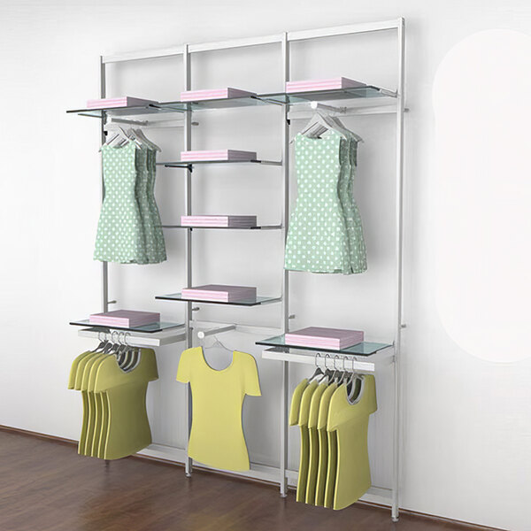 A white wall-mounted Udizine retail clothing display rack with clothes hanging on it.