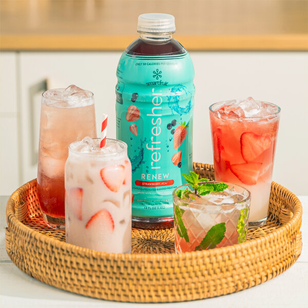 A straw basket with a blue Smartfruit Renew Strawberry Acai drink in it.