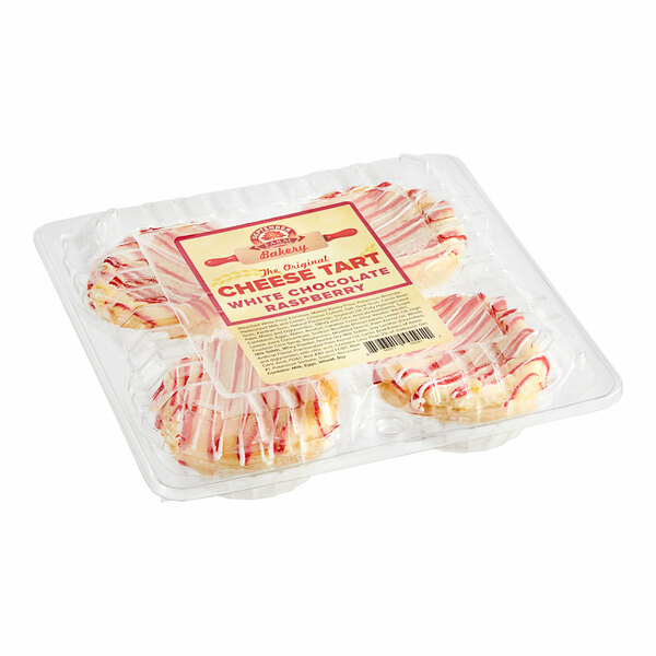 A plastic container of September Farm white chocolate raspberry cheese tarts.
