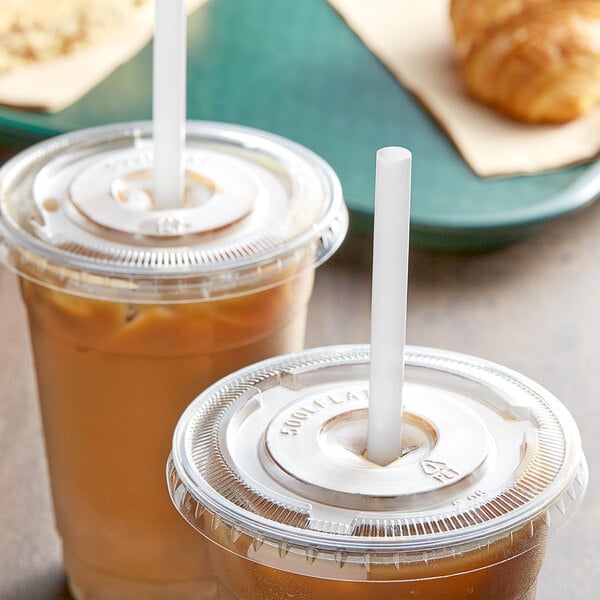 Two plastic cups of iced coffee with EcoChoice PLA straws and a croissant.