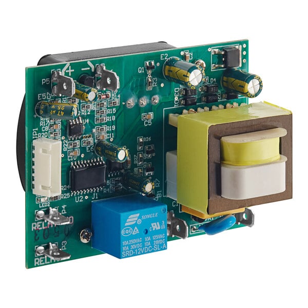 A green circuit board with a yellow square object and small electronic components.