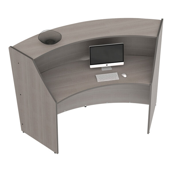 A Correll curved reception counter with a computer and keyboard on it.