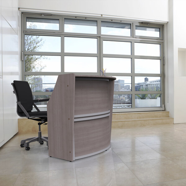 A Correll curved ash laminate reception counter in a room with large windows.