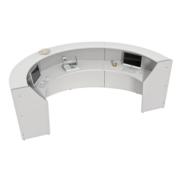 A white Correll curved U-shape reception counter with a computer and monitor on it.