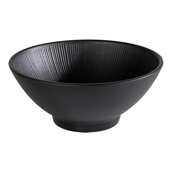 A black APS Nero melamine ramen bowl with a spiral design on a curved edge.