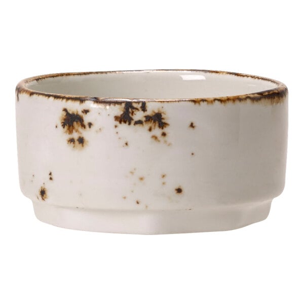 A Steelite white taster bowl with brown spots.