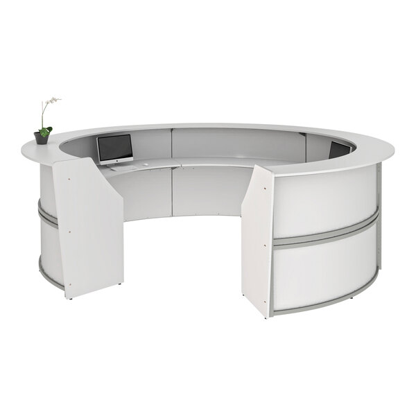 A white curved Correll reception desk with a laptop on it.