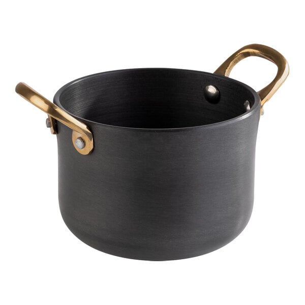 A black round aluminum serving pot with brass handles.