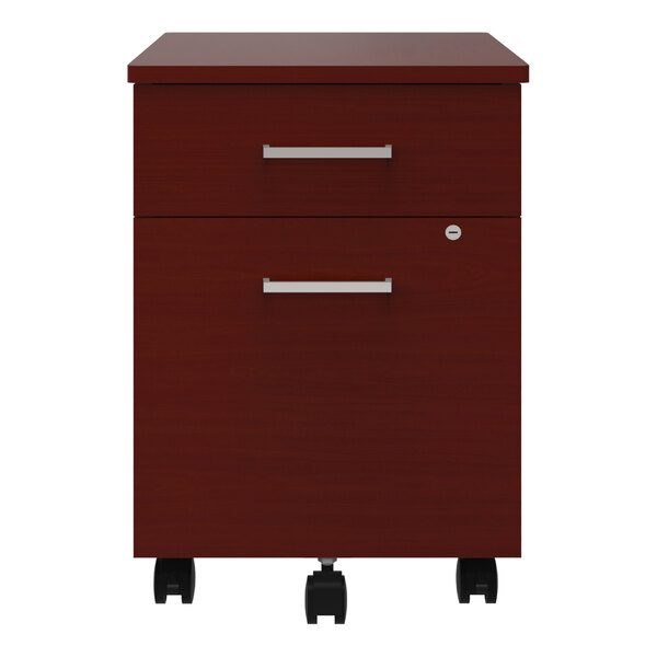 A Correll steel mobile pedestal filing cabinet with cherry laminate drawers and black wheels.