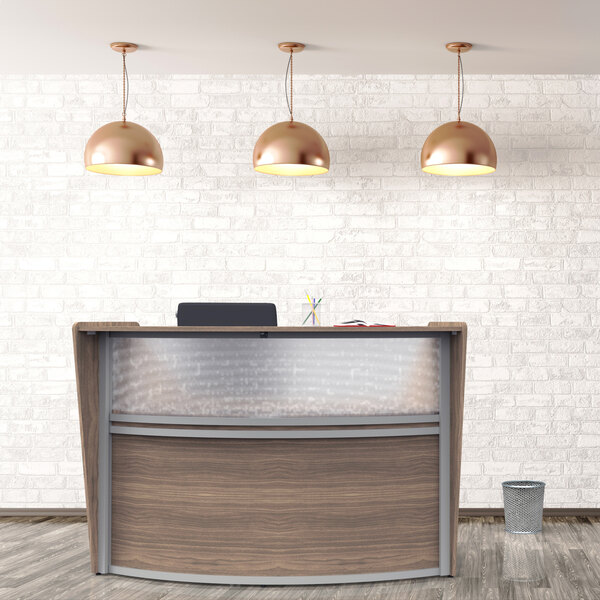 A Correll walnut laminate curved reception desk with pendant lights above.