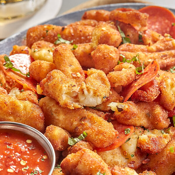 Breaded Pizza Cheese Curds on a plate with dipping sauce.