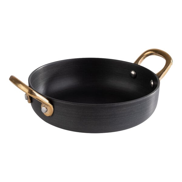 A black round aluminum serving pot with brass handles.