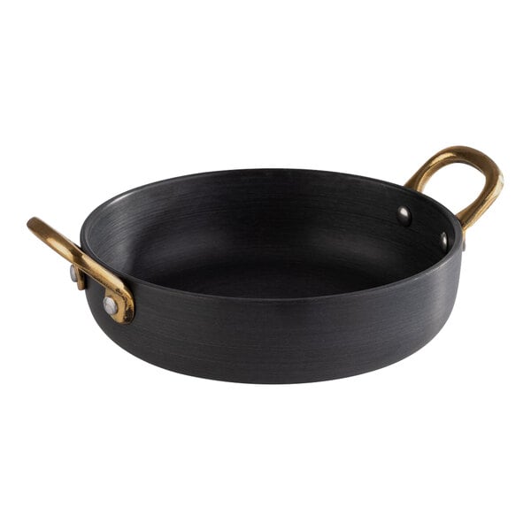 A black round aluminum serving pot with brass handles.