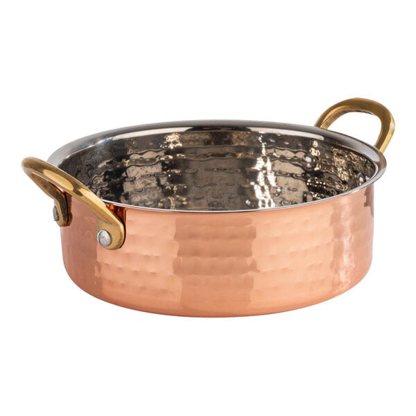 An APS Mumbai round hammered copper serving pot with a handle.