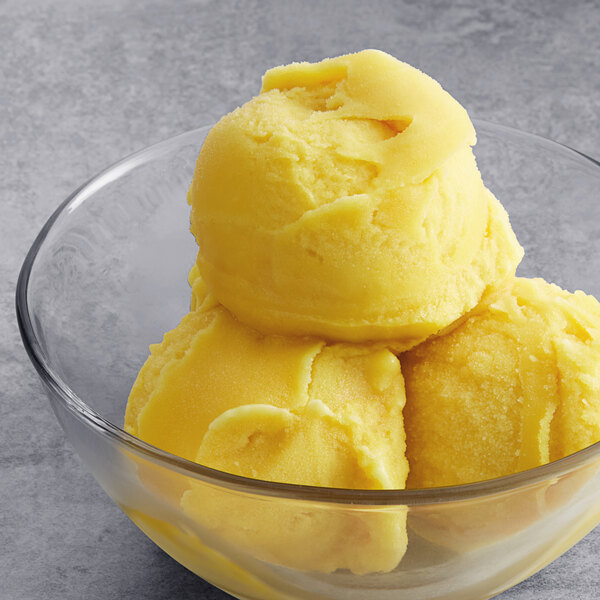 A bowl of Tropical Acai Premium Pineapple Sorbet with three scoops.