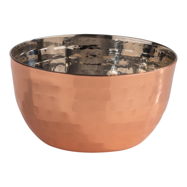 An APS Mumbai round hammered copper bowl with a metal rim.