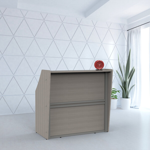 A Correll ash laminate reception desk with a red clock on it.
