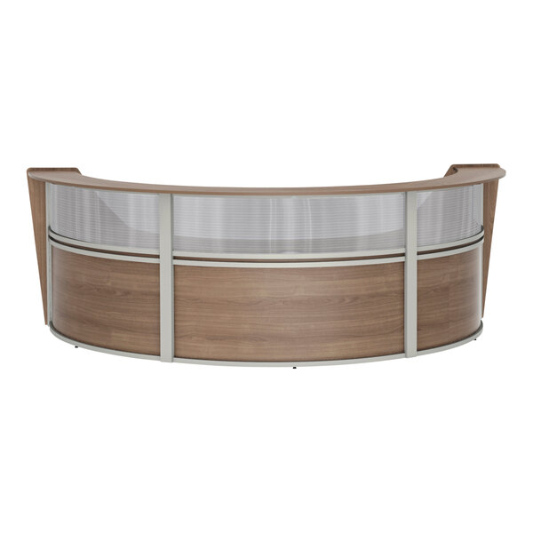 A Correll walnut laminate curved reception desk with a glass top.