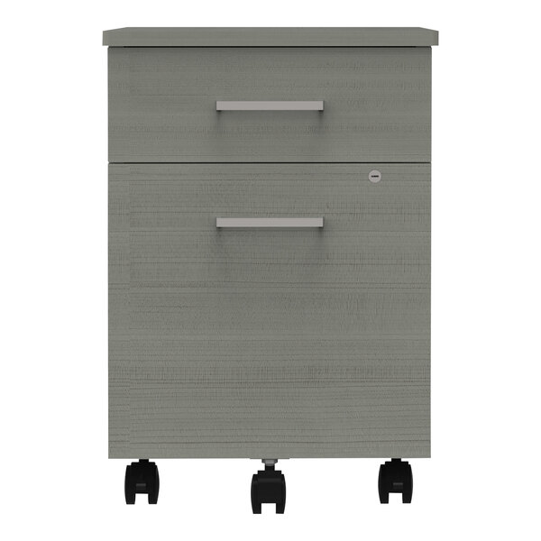 A grey Correll mobile pedestal filing cabinet with black wheels.
