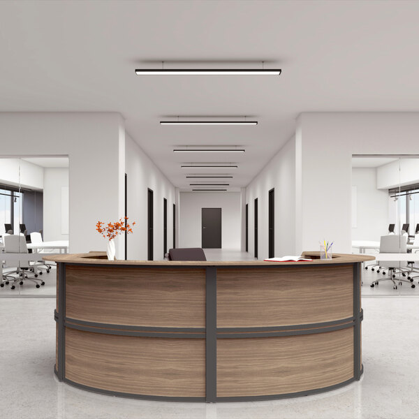 A walnut laminate curved U-shape reception counter with a book on top.
