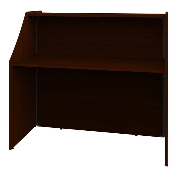 A brown reception desk with a shelf on top.