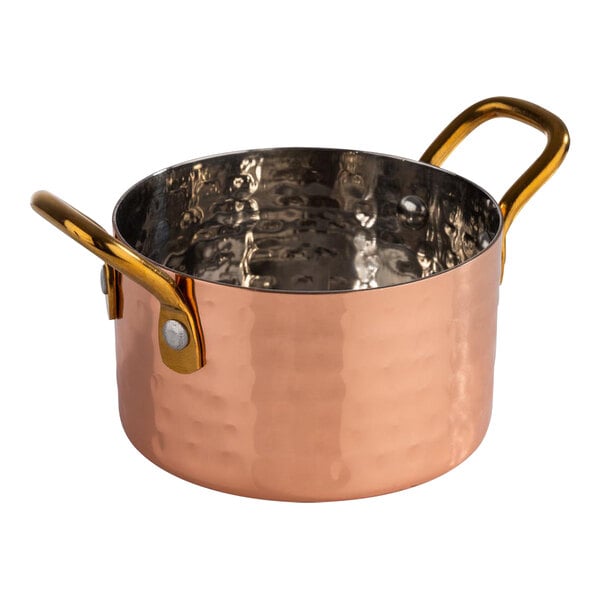 An APS Mumbai hammered copper serving pot with two handles.