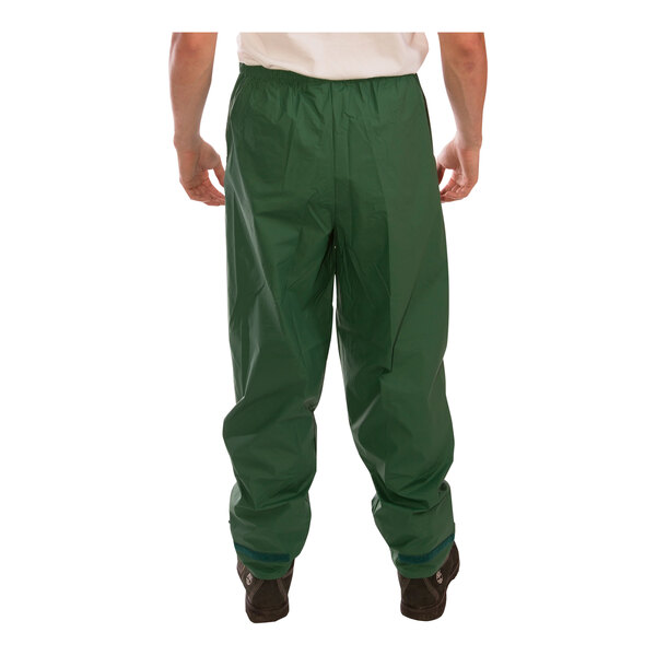 A person wearing a green Tingley rainsuit.