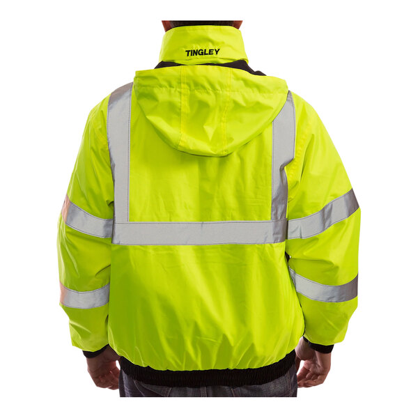 A person wearing a Tingley yellow and black industrial work jacket.