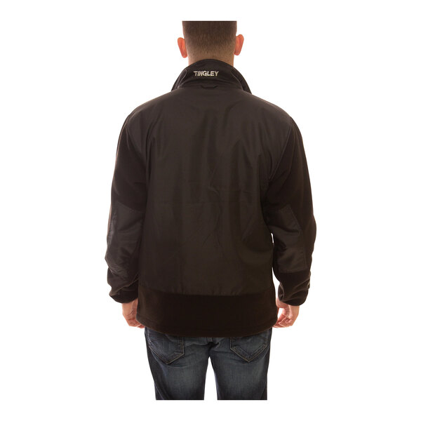 A man wearing a black Tingley Phase 2 heavy weight fleece jacket.
