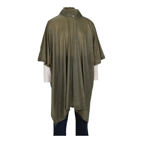A person wearing a green Tingley rain poncho with a hood and pockets.