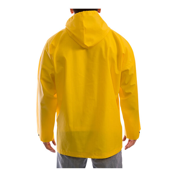 A person wearing a Tingley yellow rain jacket with a hood.