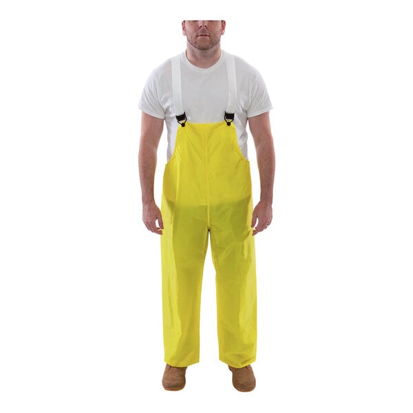 A man wearing Tingley yellow overalls.